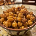 A side view of crispy chickpeas, highlighting their texture and seasoning.