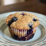 Delicious oat flour blueberry muffins captured closely, showing their fluffy texture and plump blueberries.