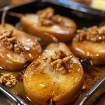 Juicy baked pears with a golden honey glaze and crunchy walnut topping.