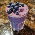 Detailed shot of a thick blueberry protein shake with a creamy texture.