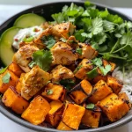 Colorful Chicken and Sweet Potato Bowl showcasing cooked ingredients and garnishes.