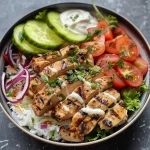 A side view of a delicious Chicken Shawarma Bowl filled with vibrant toppings.