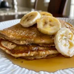 Appetizing display of flourless banana pancakes, showcasing a soft texture and rich color.