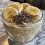 Detailed shot of chia pudding with a glossy surface and colorful fruit topping.