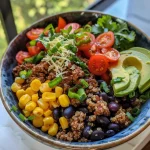 Close-up of a nutritious beef and quinoa bowl with fresh ingredients.