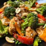 Colorful chicken stir-fry with cashews, garlic, and fresh vegetables.