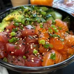 A side view of a colorful Spicy Tuna Poke Bowl with diced tuna, avocado, and sesame seeds.