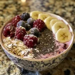 Side profile of a colorful smoothie bowl, showcasing vibrant toppings like sliced bananas and chocolate nibs.