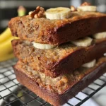 Close-up view of mini banana bread loaf cakes on a wooden surface.