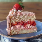 Side view of a slice of strawberry cake made with Greek yogurt, showing its moist layers.