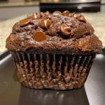 Close-up view of a double chocolate banana muffin, showcasing its rich, chocolatey texture and banana content.