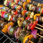 Colorful grilled vegetable skewers featuring bell peppers, zucchini, red onion, and mushrooms.