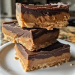 A close-up view of No-Bake Peanut Butter Cup Bars topped with flaky sea salt.