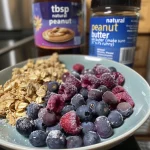 Detailed shot of a berry crumble with a golden crust and fresh berries.