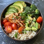 A hearty rotisserie chicken bowl showcasing brown rice, cucumber, and avocado.