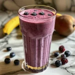 Close-up view of a colorful Almond Milk Berry Smoothie with mixed berries.