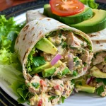 Close-up of a delectable avocado ranch tuna wrap filled with fresh ingredients.