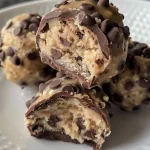 Close-up view of chocolate chip cookie dough truffles arranged on a plate.