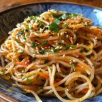 Close-up of a vibrant Cold Sesame Noodle Salad with colorful vegetables.