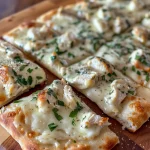 Juicy Easy Chicken Alfredo Flatbread topped with cheese and spinach.