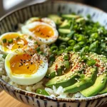 Close-up of a vibrant Easy Egg Avocado Rice Bowl featuring eggs, avocado, and rice.