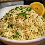 Close-up view of Greek Lemon Rice with fresh parsley and lemon zest.