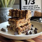 Close-up of No-Bake Chocolate Peanut Butter Oatmeal Bars with a glossy chocolate layer.