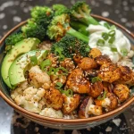Close-up of a colorful Spicy Chipotle Buddha Bowl with cauliflower rice and fresh ingredients.