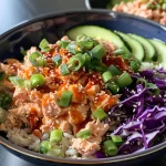 A close-up side view of a colorful Spicy Tuna Salad Bowl with fresh ingredients.