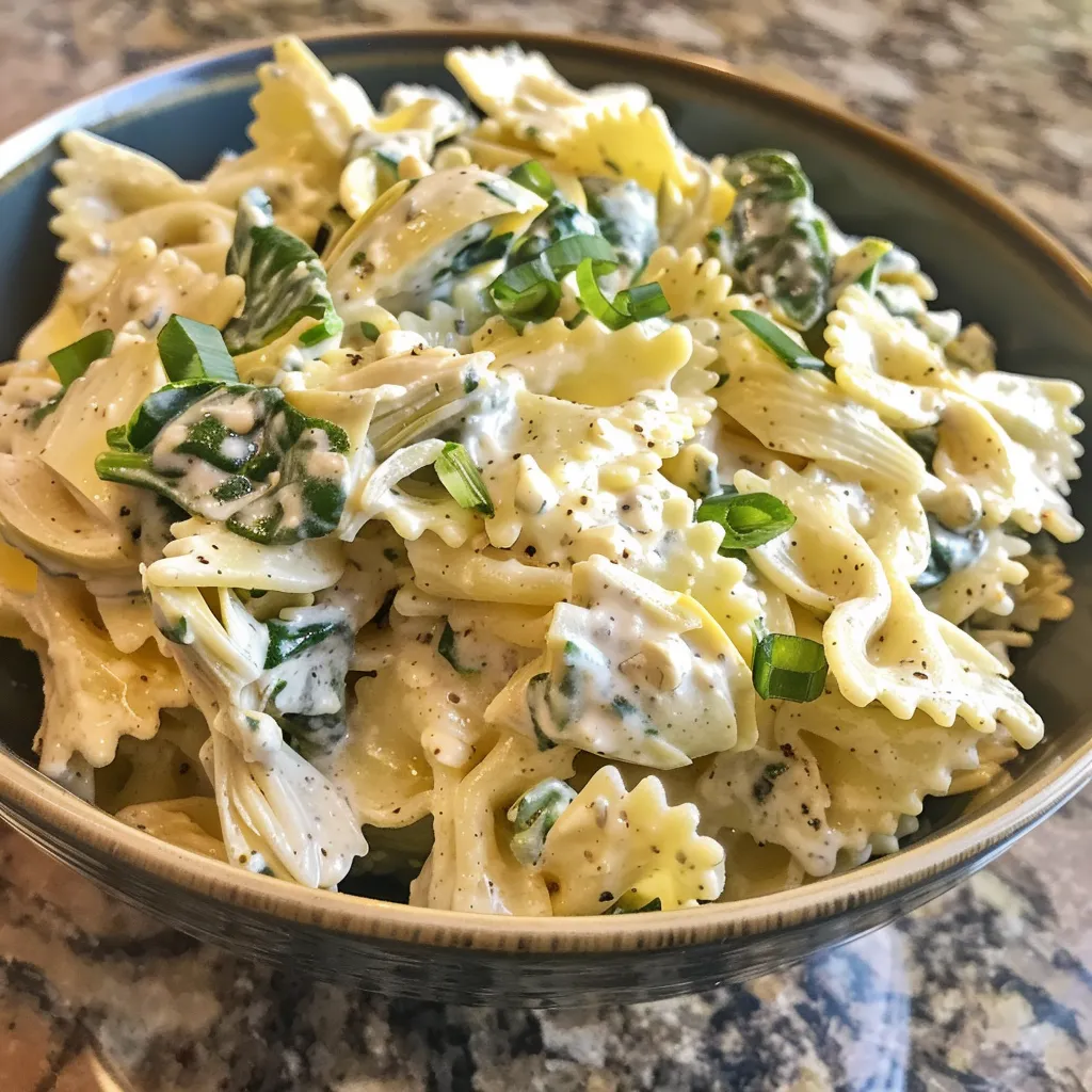 A delicious serving of pasta salad featuring colorful rotini, green onions, and creamy dressing.