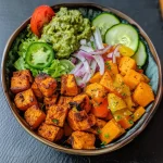 A vibrant Sweet Potato Bowl with colorful ingredients, including sweet potatoes, ground beef, and fresh vegetables.