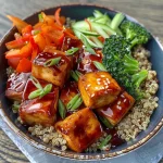 Close-up view of Teriyaki Glazed Tofu Bowl with quinoa and vegetables.