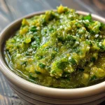 ['Close-up view of creamy avocado green salsa in a bowl, showcasing its smooth texture.', 'Side view of a vibrant avocado green salsa with fresh ingredients surrounding it.', 'An iPhone photo capturing a bowl of avocado green salsa with a glossy finish.', 'Juicy avocado green salsa displayed in a bowl, highlighting its fresh ingredients.']