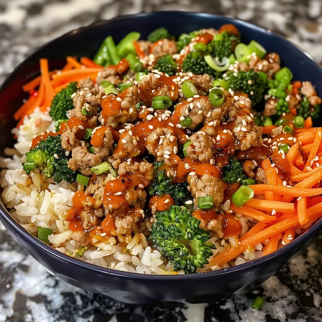 Close-up view of a vibrant Bang Bang Turkey Bowl with colorful vegetables and rice.