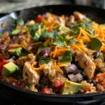 ['A close-up side view of a Chicken Quinoa Skillet, showcasing vibrant bell peppers and juicy chicken pieces.', 'Juicy Chicken Quinoa Skillet with colorful vegetables and a sprinkle of cheese, viewed from the side.', 'A detailed image of Chicken Quinoa Skillet featuring diced chicken, quinoa, and fresh toppings.', 'Close-up of a Chicken Quinoa Skillet, highlighting the mixture of quinoa, chicken, and assorted vegetables.']