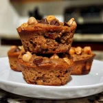 ['Close-up view of moist chickpea muffins with a golden brown crust.', 'Side angle of freshly baked chickpea muffins showcasing their fluffy texture.', 'A plate of chickpea muffins, highlighting their tempting outer layer and soft inside.', 'Juicy chickpea muffins on a rustic surface, emphasizing their appetizing appearance.']