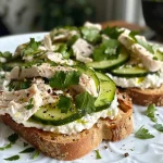 ['Close-up view of a high-protein chicken and cucumber toast topped with cottage cheese and parsley.', 'Side angle of a delicious chicken cucumber toast garnished with creamy cottage cheese and fresh herbs.', 'Juicy grilled chicken slices and cucumber on high-protein toast with a dollop of cottage cheese.', 'Detailed image of a nutritious chicken cucumber toast showcasing vibrant toppings and high-protein bread.']