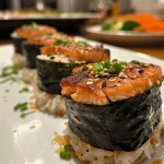['Close-up view of golden-brown salmon muffins with visible asparagus and cheese.', 'Side view of freshly baked salmon muffins featuring chopped asparagus and herbs.', 'Juicy salmon muffins displayed on a plate, showcasing their fluffy texture and ingredients.', 'Delicious salmon muffins with flaked salmon and a crusty exterior, captured in detail.']