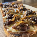 ['Close-up of a juicy tartine topped with beef and caramelized onions.', 'Side view of tartines featuring beef, caramelized onions, and arugula.', 'Plate of grilled tartines with layers of beef, onions, and cheddar cheese.', 'Delicious tartines showcasing tender beef and golden caramelized onions.']