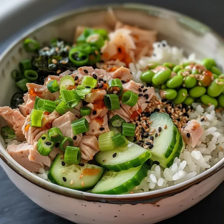 ['A close-up side view of a Tuna Mayo Rice Bowl with vibrant ingredients.', 'A detailed look at a Tuna Mayo Rice Bowl featuring layers of rice, tuna, and vegetables.', 'A Tuna Mayo Rice Bowl captured from a side angle showcasing fresh toppings.', 'A colorful Tuna Mayo Rice Bowl highlighting avocado, cucumber, and sesame seeds.']