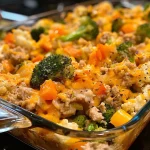['Close-up view of a low-carb turkey casserole with colorful vegetables and melted cheese.', 'Side angle of a turkey casserole, showcasing layers of ground turkey, cauliflower, and cheese.', 'Juicy turkey casserole filled with broccoli and bell peppers, topped with golden melted cheddar.', 'Delicious low-carb turkey casserole, featuring a variety of vegetables and a creamy texture.']