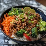['Close-up of a delicious Bang Bang Turkey Bowl featuring ground turkey, colorful vegetables, and rice.', 'A vibrant side view of a Bang Bang Turkey Bowl with ground turkey, red bell pepper, broccoli, and jasmine rice.', 'A mouthwatering dish of Bang Bang Turkey Bowl showing juicy turkey, carrots, and topped with sesame seeds.', 'Close view of a turkey bowl filled with vegetables, rice, and savory sauces in a bright bowl.']
