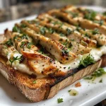 ['Close-up view of a crunchy chicken cucumber toast topped with cottage cheese and parsley.', 'Side view of high-protein chicken toast featuring fresh cucumber slices and cottage cheese.', 'Juicy grilled chicken on whole grain toast, garnished with cucumber and parsley.', 'Tasty chicken cucumber toast with a creamy cottage cheese spread and vibrant toppings.']