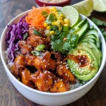 ['A close-up view of a Hot Honey Chicken Bowl featuring juicy chicken, rice, and colorful toppings.', 'A vibrant Hot Honey Chicken Bowl showcasing chicken thighs, avocado, and fresh vegetables against a light background.', 'Side view of a deliciously assembled Hot Honey Chicken Bowl with rice, grilled chicken, and garnishes.', 'Close-up of a Hot Honey Chicken Bowl highlighting grilled chicken, garnished with sesame seeds and lime wedges.']