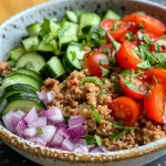 ['Close-up view of a Mediterranean bowl filled with ground turkey and quinoa, garnished with vegetables.', 'Side angle of a Mediterranean dish showcasing ground turkey, quinoa, cucumbers, and tomatoes.', 'Colorful Mediterranean bowl featuring ground turkey and quinoa with fresh ingredients.', 'Detailed shot of Mediterranean cuisine with ground turkey, quinoa, and bright veggies.']
