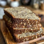 ['Close-up of a slice of quinoa bread showcasing its texture and seeds.', 'Side view of freshly baked quinoa bread with visible seeds and a crusty surface.', 'Juicy and moist quinoa bread slice, revealing its fluffy interior and seed topping.', 'Detailed view of quinoa bread with a golden crust, highlighting its wholesome ingredients.']