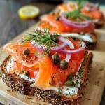 ['Close-up of a slice of smoked salmon toast with vibrant colors and textures.', 'Side view of a delicious smoked salmon toast topped with herbs and crème fraîche.', 'Detailed shot of smoked salmon on rustic bread, garnished with dill and chives.', 'Appetizing smoked salmon toast presented on a wooden board with lemon slices.']
