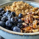 Close-up view of vibrant blueberry maple walnut trail mix in a bowl.