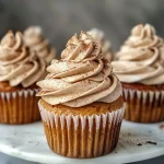 Close-up of a brown butter dirty chai cupcake with creamy frosting.