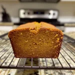 Close-up of a slice of butternut squash bread with a moist texture.